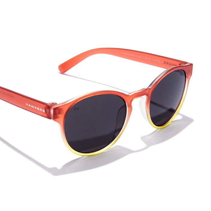 Hawkers Gafas de Sol BELAIR KIDS para Niños Redondas Naranja Transparente