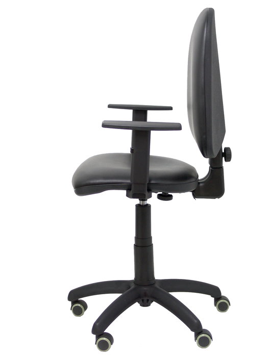 Chaise de bureau Aýna avec mécanisme Contact permanent de base, revêtue de simili cuir noir. Équipée d'une base en polyamide noir, d'accoudoirs 1D et de roulettes pour parquet