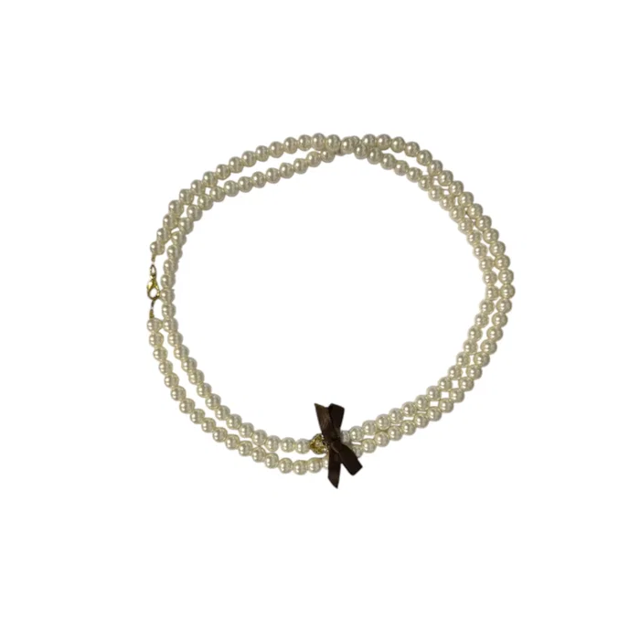 Shiseido Bracelet en métal avec perle blanche Shiseido Bracelet en métal avec perle blanche